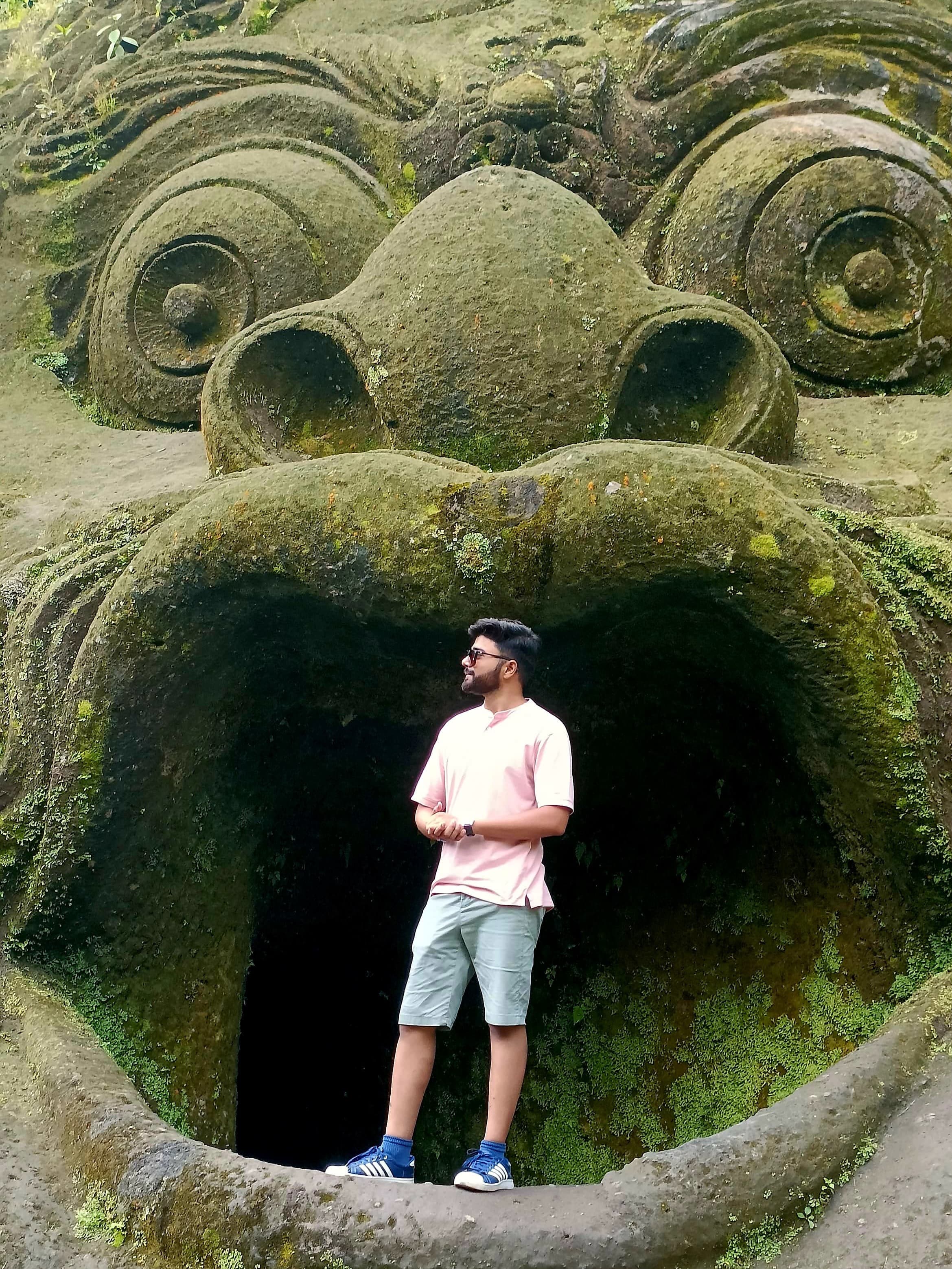 Dhruvin standing in front of an architectural structure in Bali